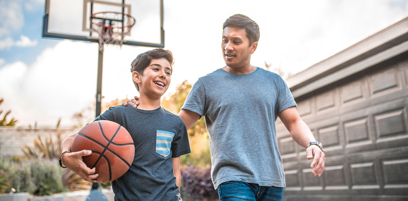 Father and son playing basketball