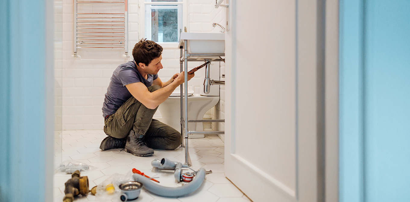 Man fixing bathroom sink